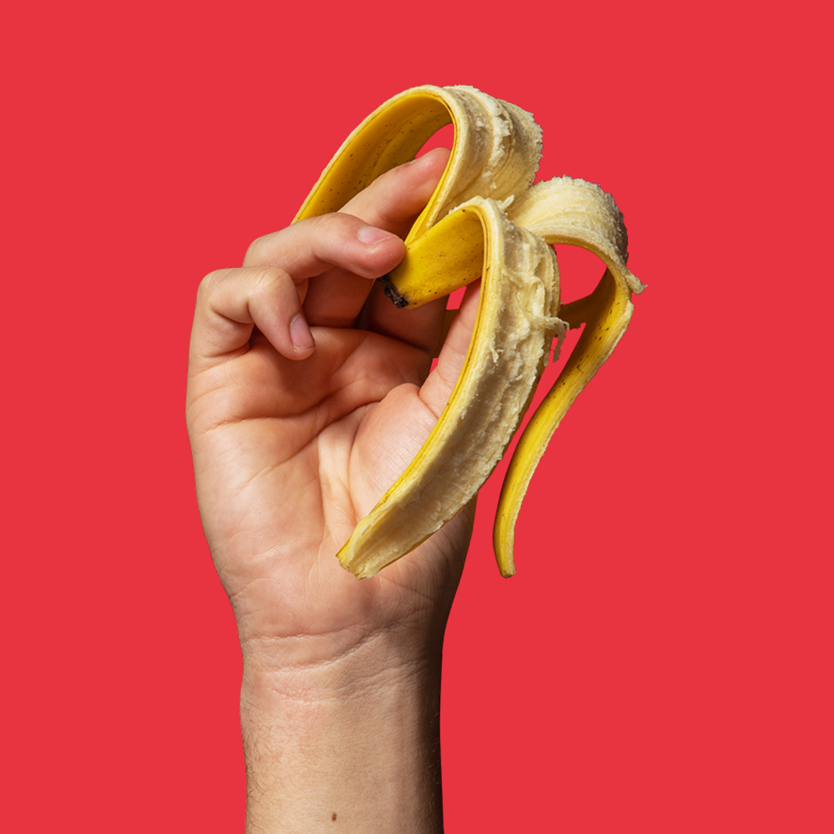 White hand holding a banana skin