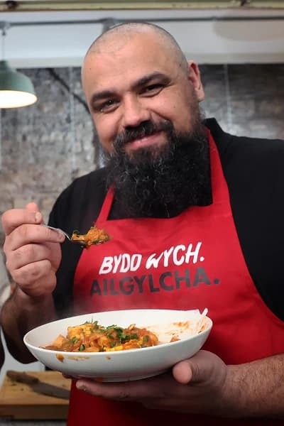 Chris tasting a flexed dish with a spoon