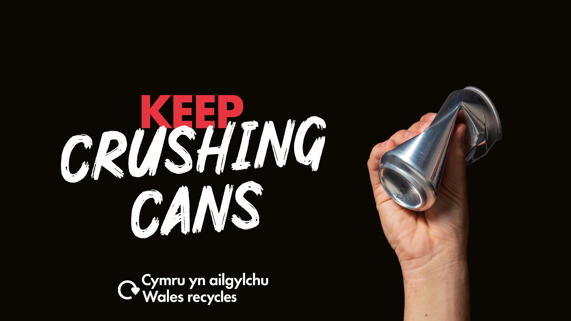 White hand holding a drink can with the slogan "Keep crushing cans"