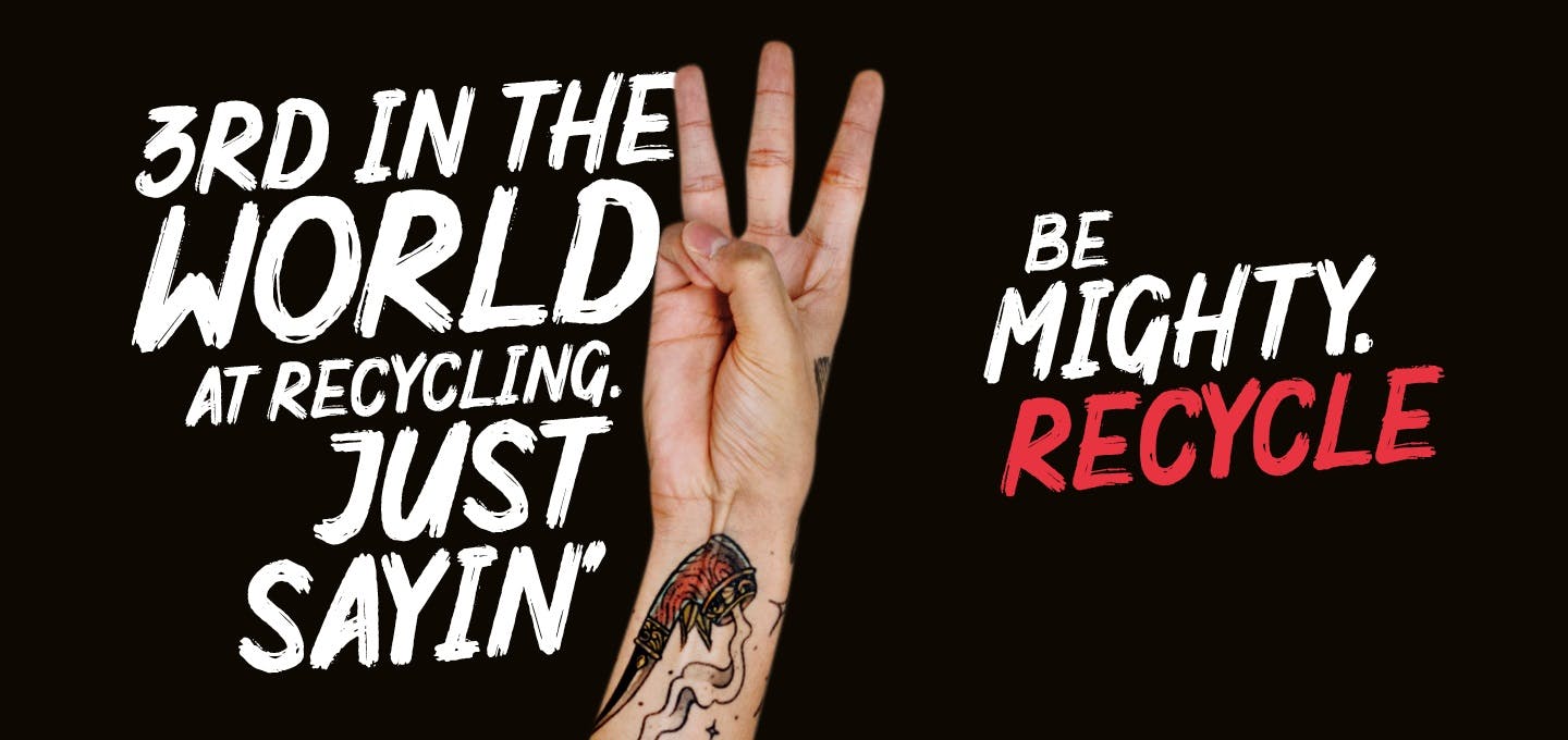 Hand holding up three fingers with the slogan "Third in the world at recycling, just saying. Be mighty recycle"
